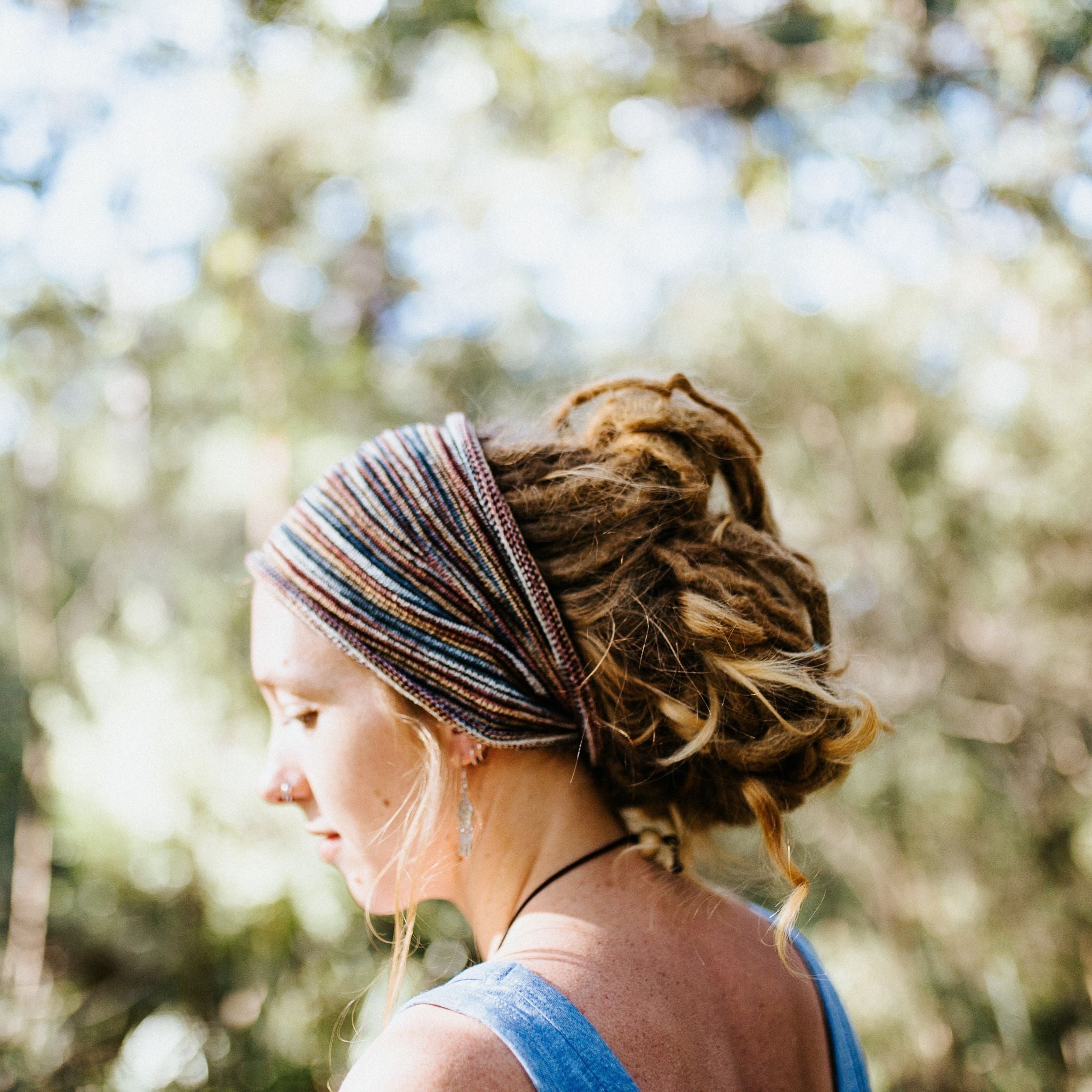 Woman with dreadlocks wearing a cotton headband outdoors