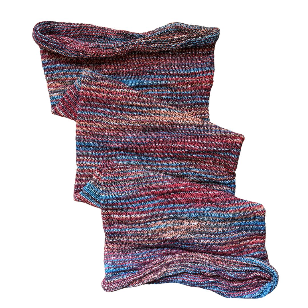 Red orange blue large cotton dreadlock sock on a white background.