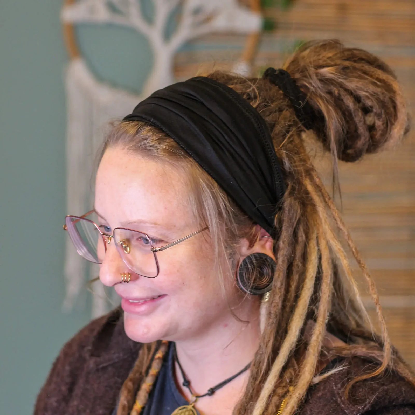 Lady wearing a Black coloured Bamboo Dreadlock Tube Headband .