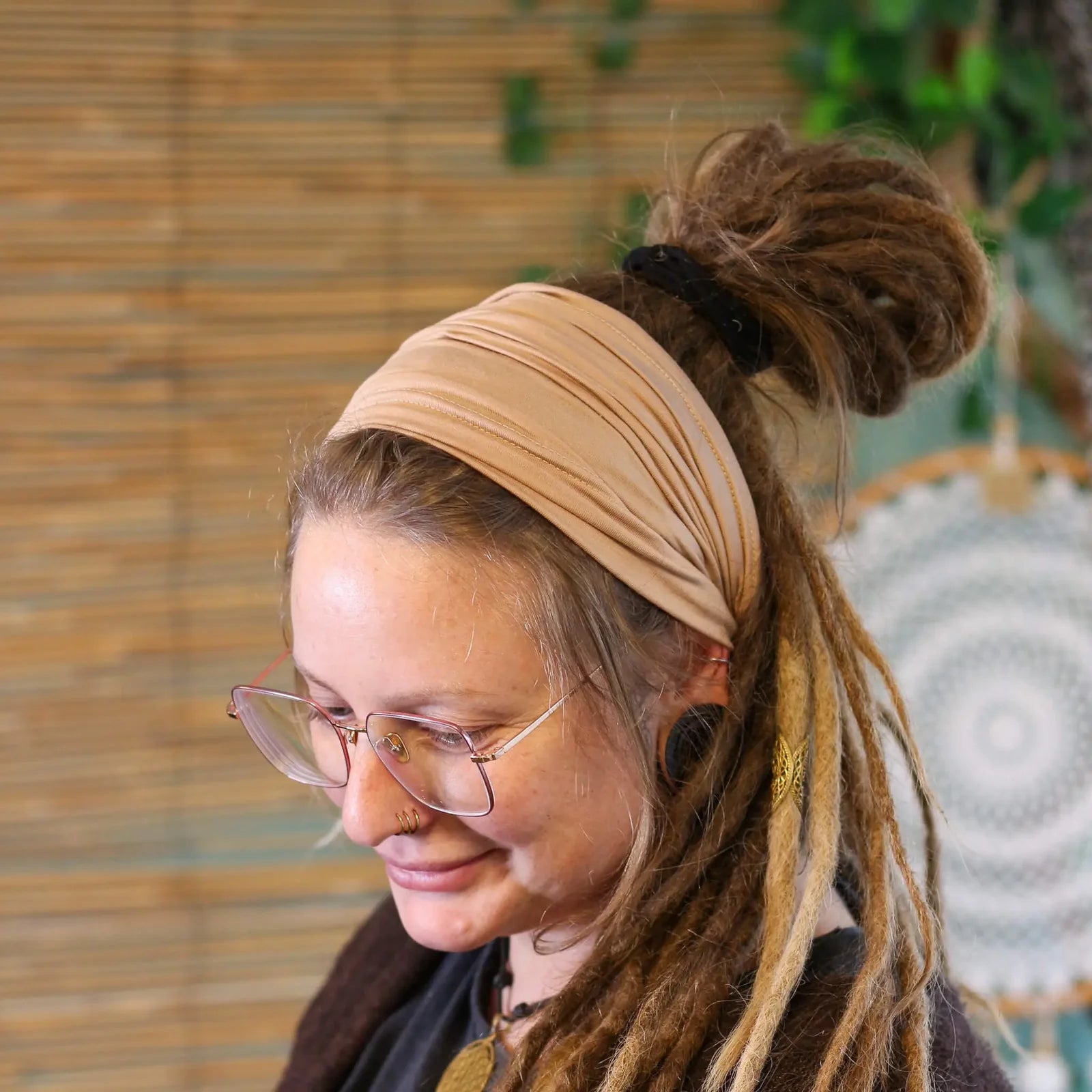 Lady wearing a cream coloured Bamboo Dreadlock Tube Headband.