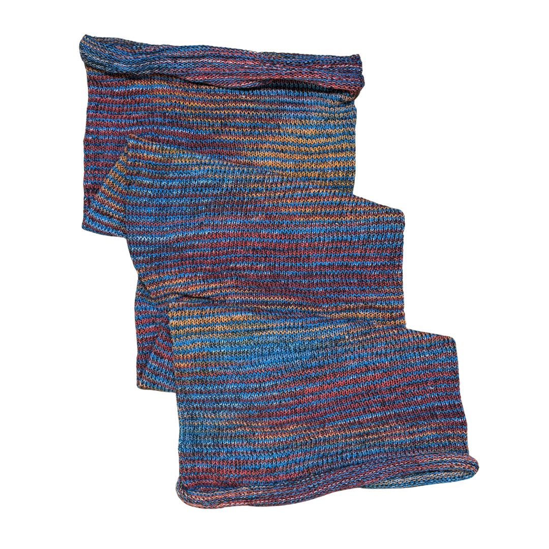 Blue red orange large cotton dreadlock sock on a white background.