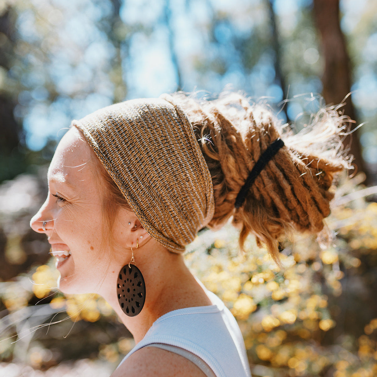 Woman with braided hair wearing a headband outdoors