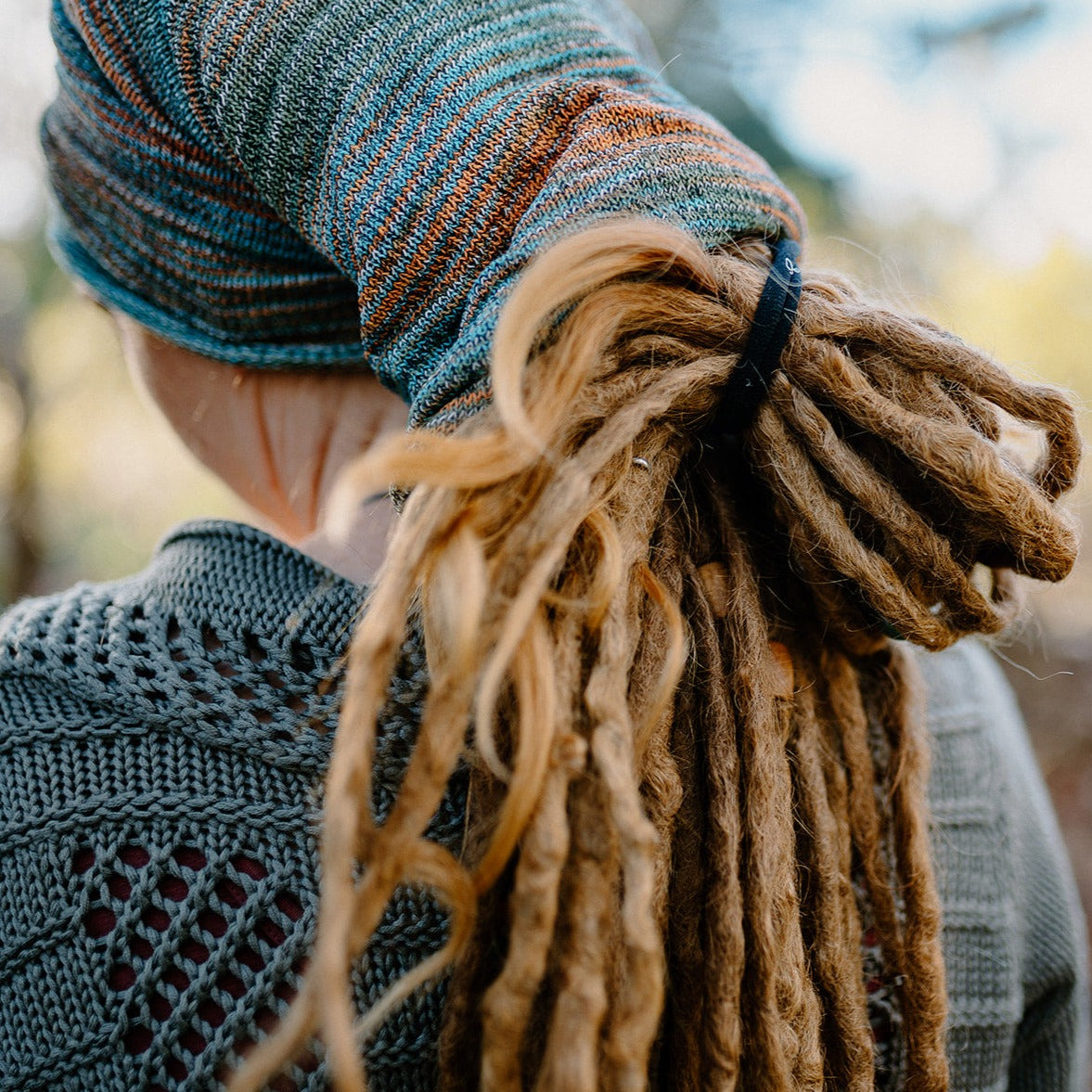 lady wearing a large cotton dreadlock sock.