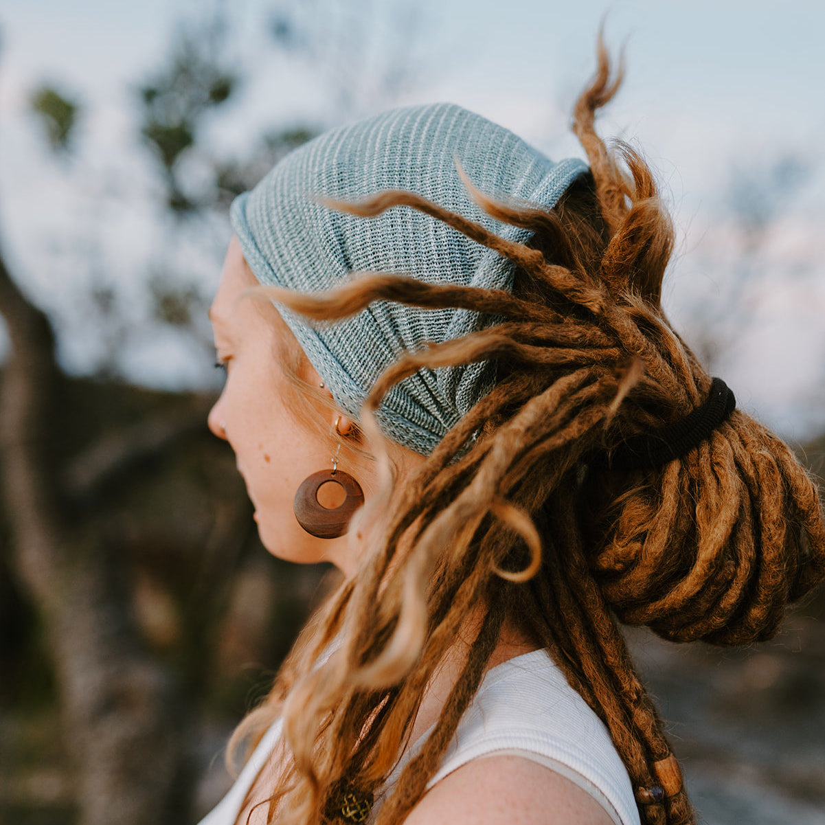 Person with dreadlocks wearing a cotton hair wrap.