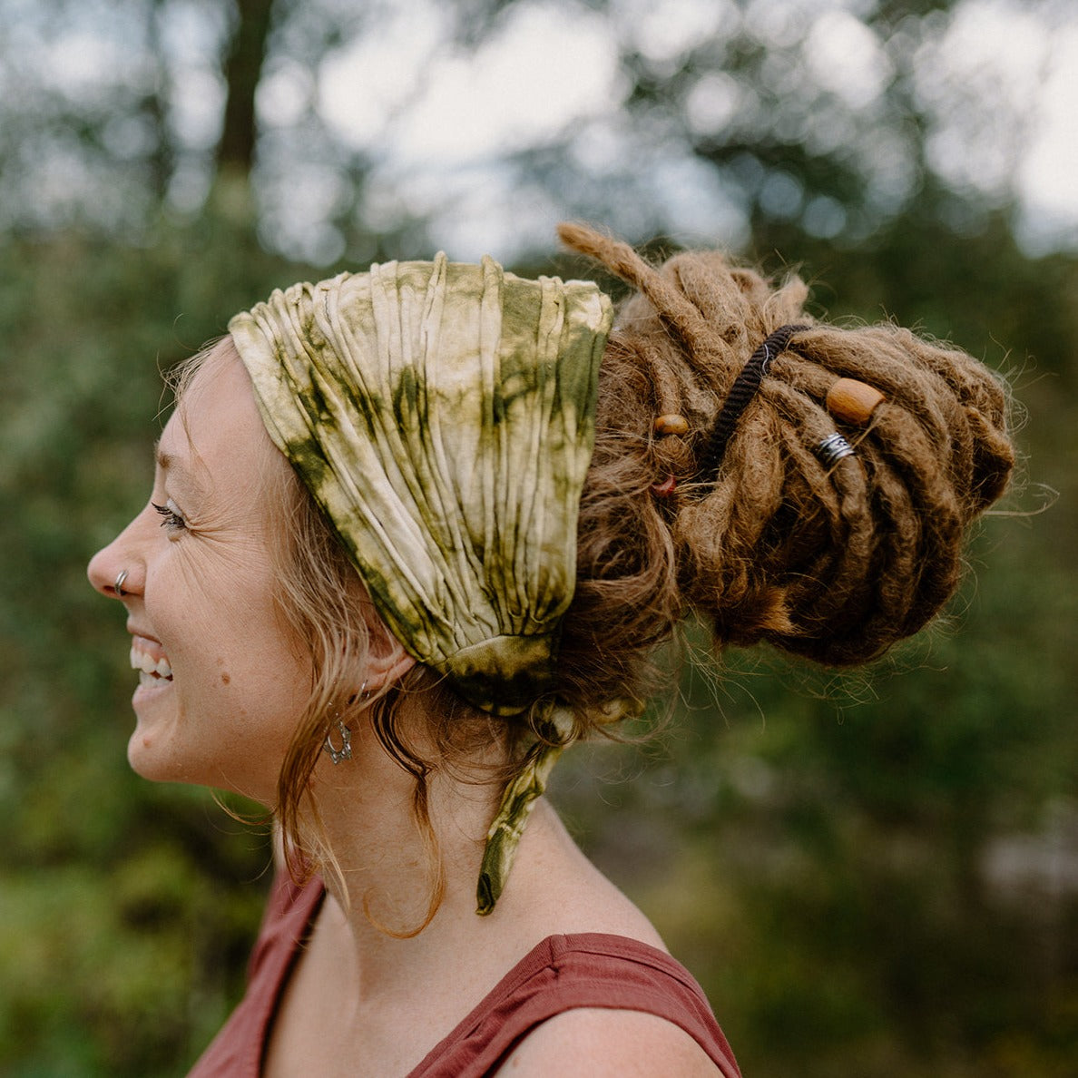 Lady wearing a cotton tie-up hair wrap in a natural setting