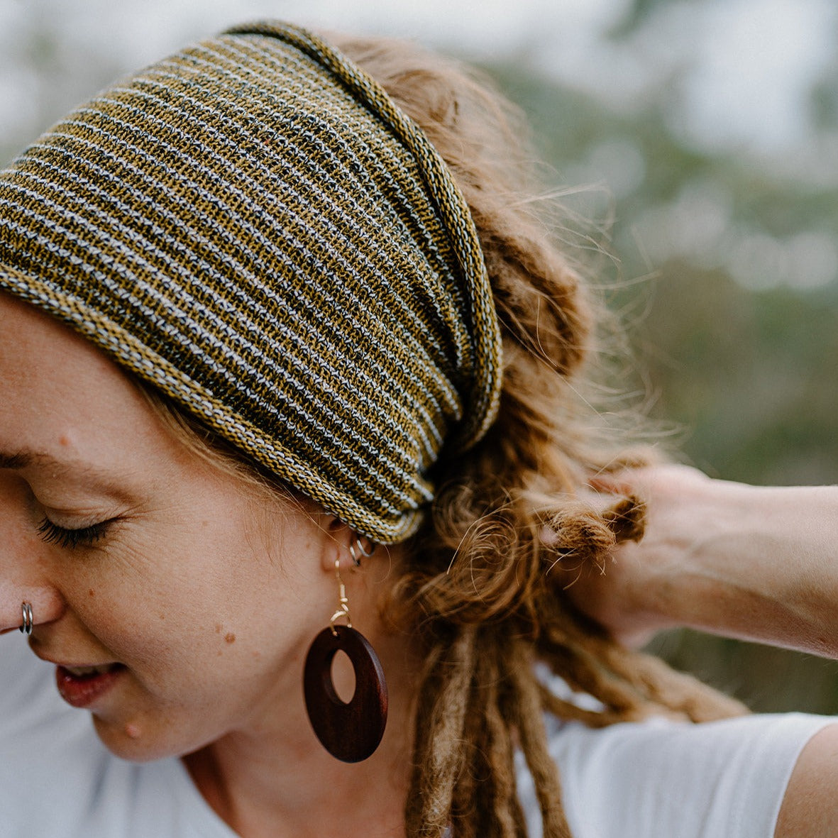 Woman with dreadlocks wearing a cotton headband outdoors