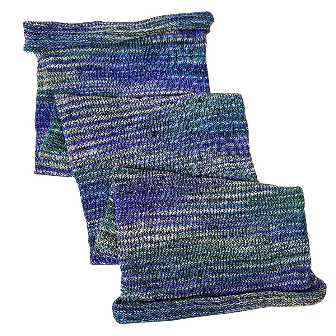 Green and purple large cotton dreadlock sock on a white background.