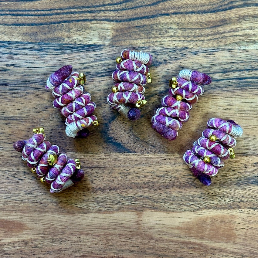 Mini sized Pink, orange, and white wire dreadlock tie, spiralock, with gold shapes.