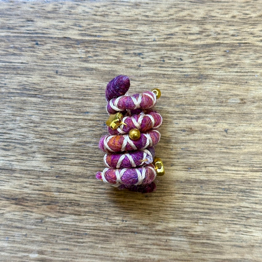 Mini sized Pink, orange, and white wire dreadlock tie, spiralock, with gold shapes.