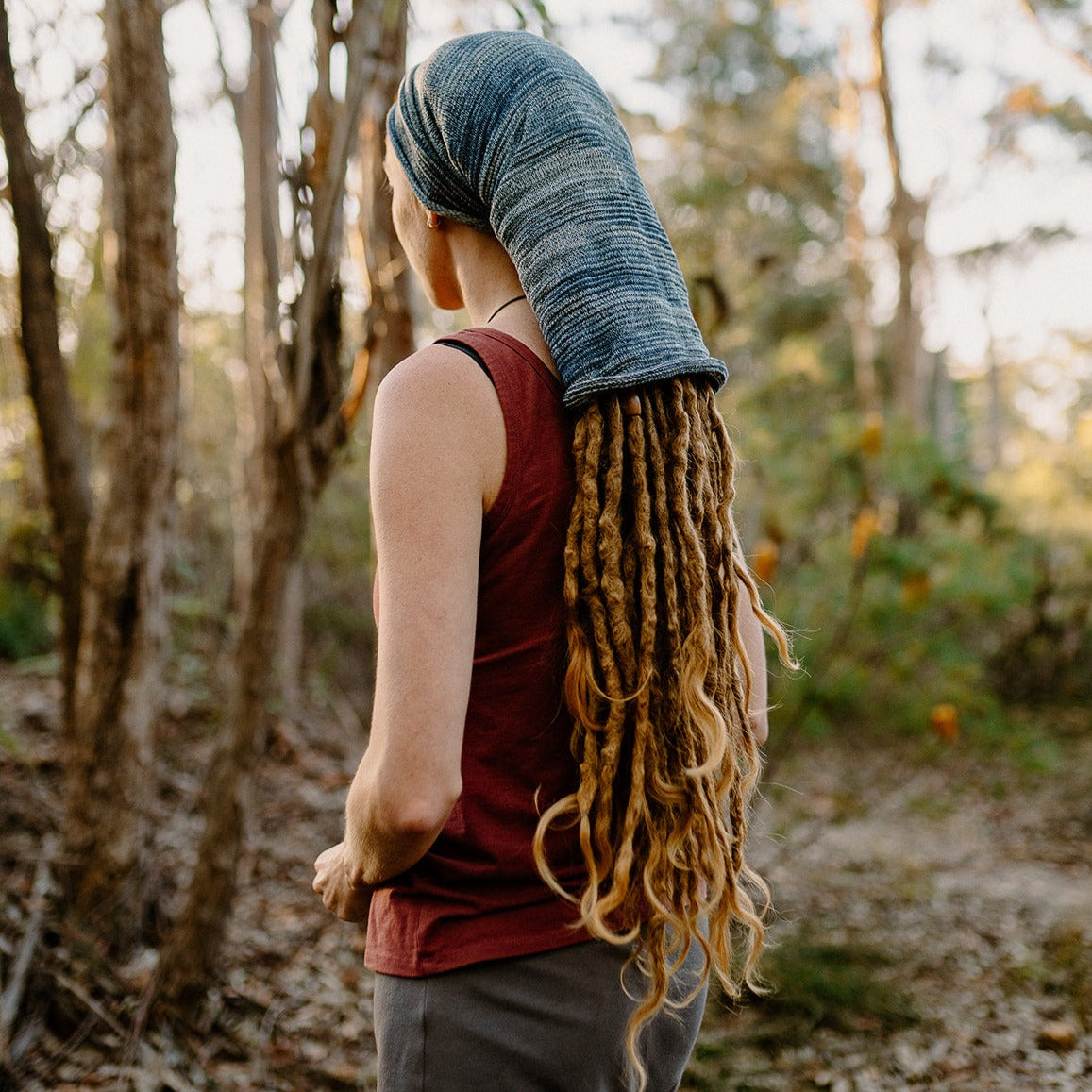 Lady wearing a large cotton dreadlock sock in a bush setting