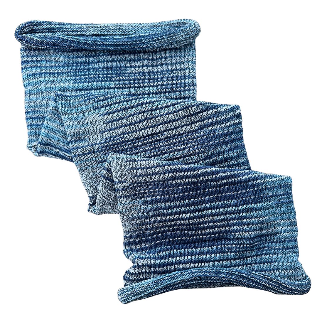 Varied blue large cotton dreadlock sock on a white background.