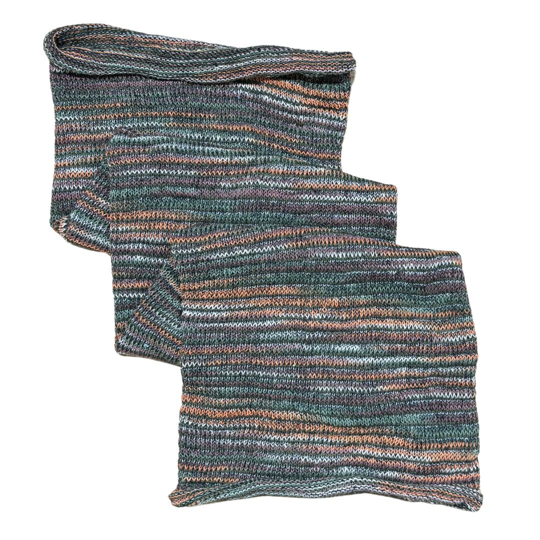 Green orange brown large cotton dreadlock sock on a white background.