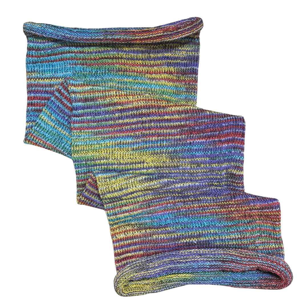 Rainbow coloured large cotton dreadlock sock on a white background.