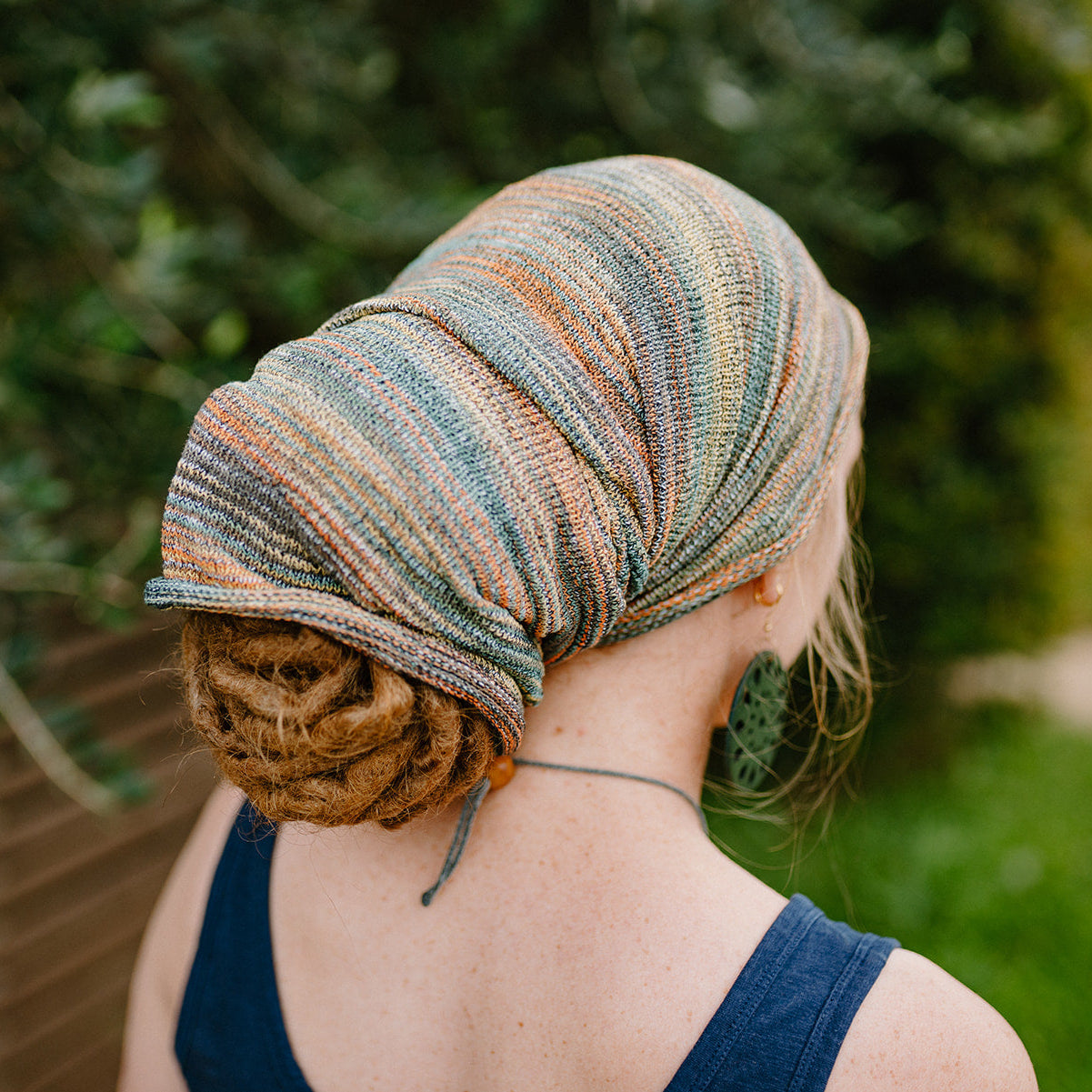 lady wearing a orange blue large cotton dreadlock sock.