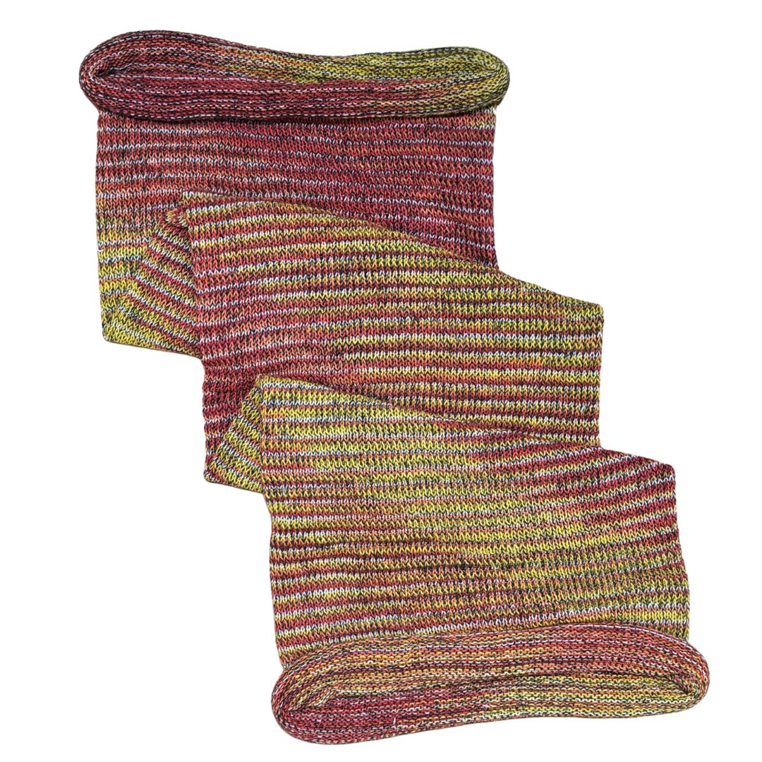 Red and yellow large cotton dreadlock sock on a white background.