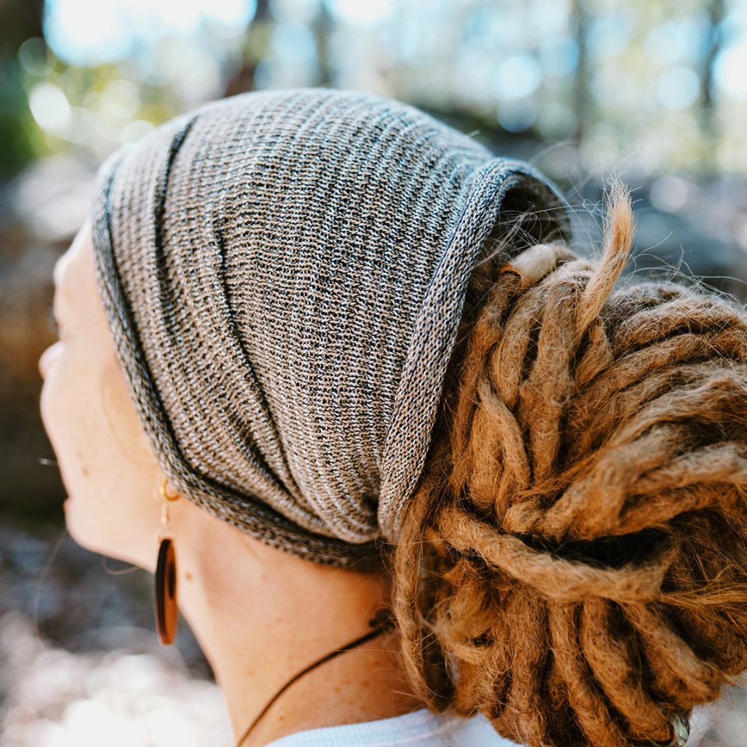 A person wearing a Brown wide cotton headband.
