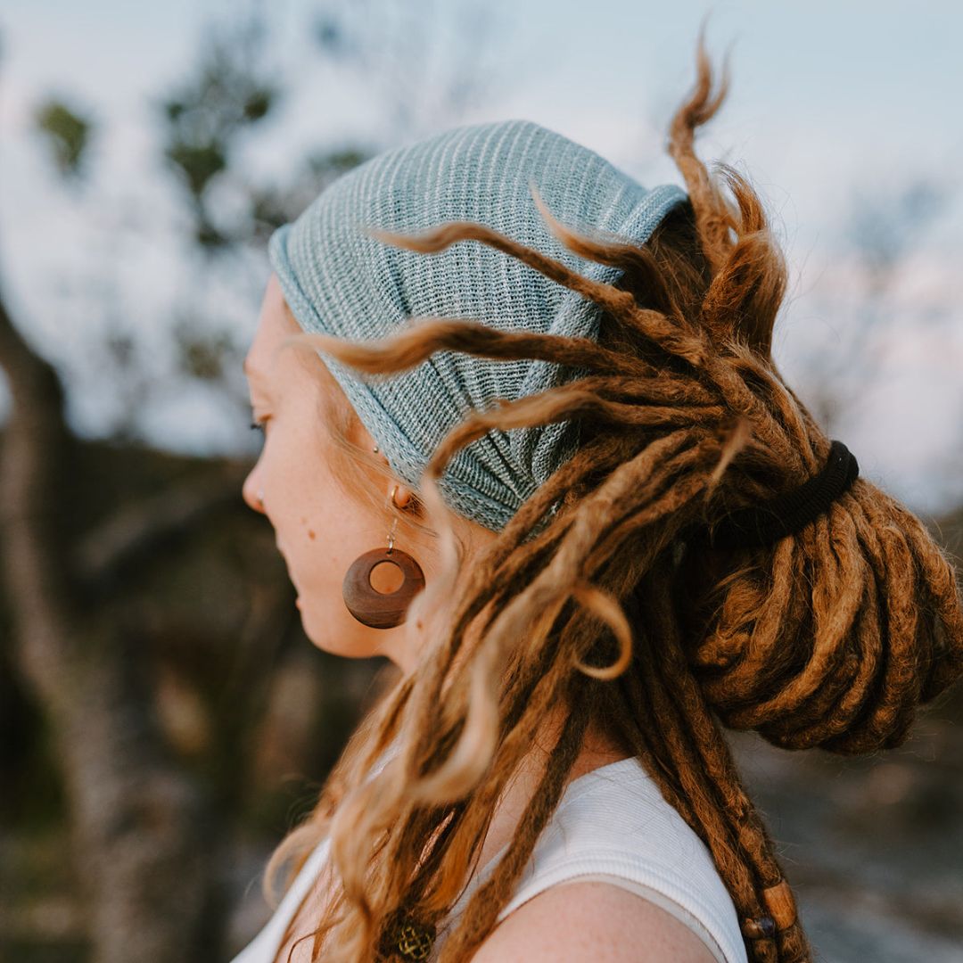 A person wearing a light blue wide cotton headband.