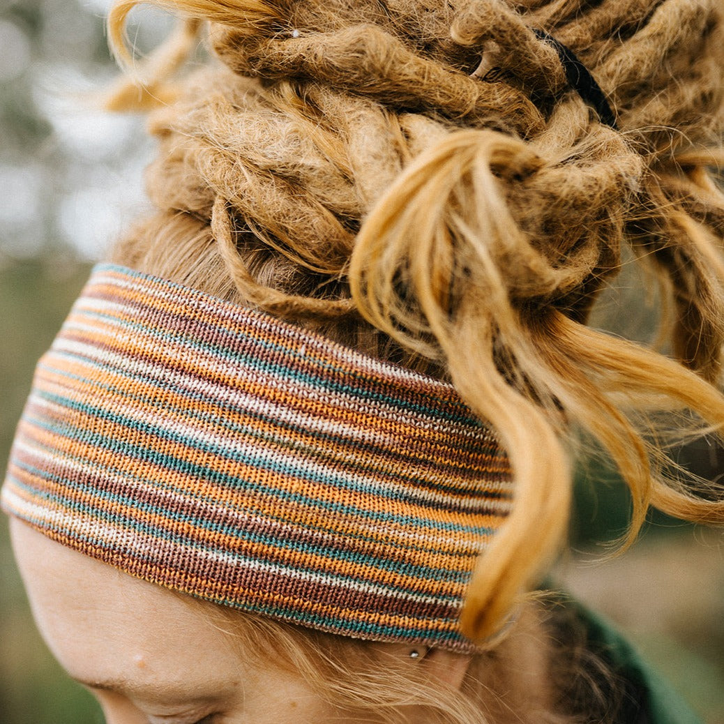 Close-up image of a person wearing a multicolored stitched cotton headband.