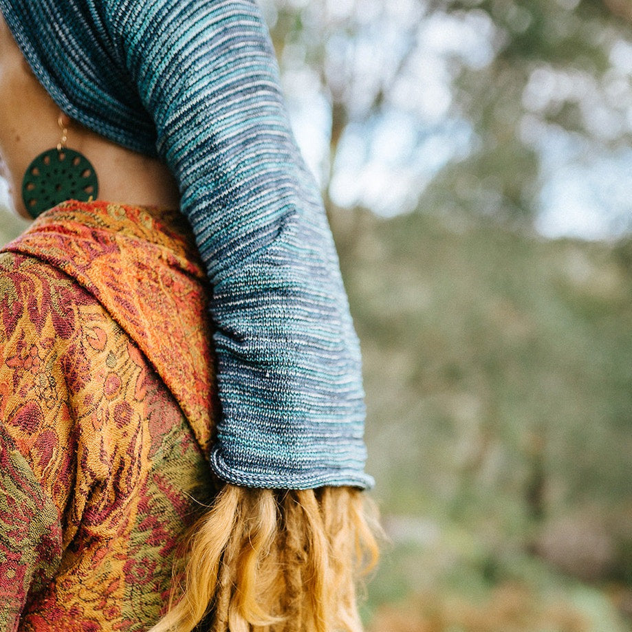 Lady wearing a blue white stripe large cotton dreadlock sock
