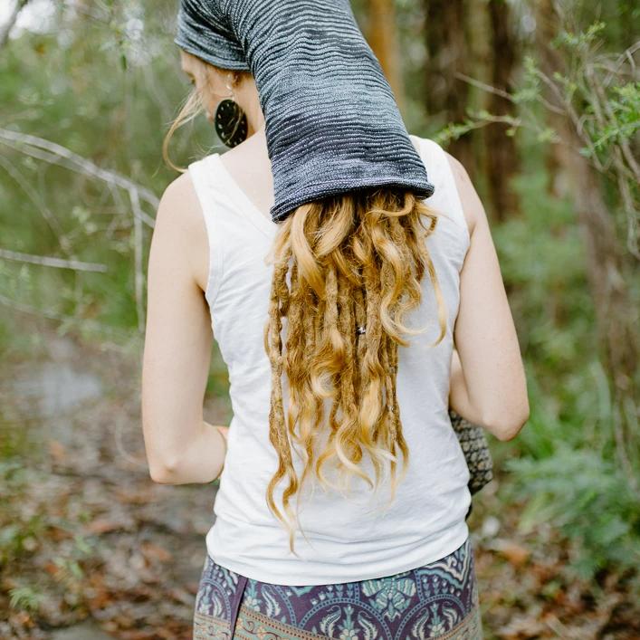 Lady wearing a large cotton dreadlock sock.