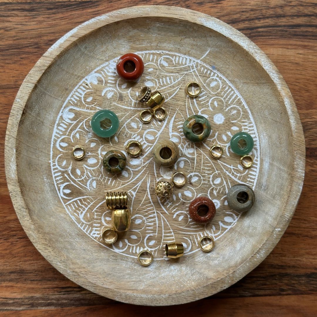 Green Gold and Red Dreadlock Beads Mix on a wooden background - Mountain Dreads