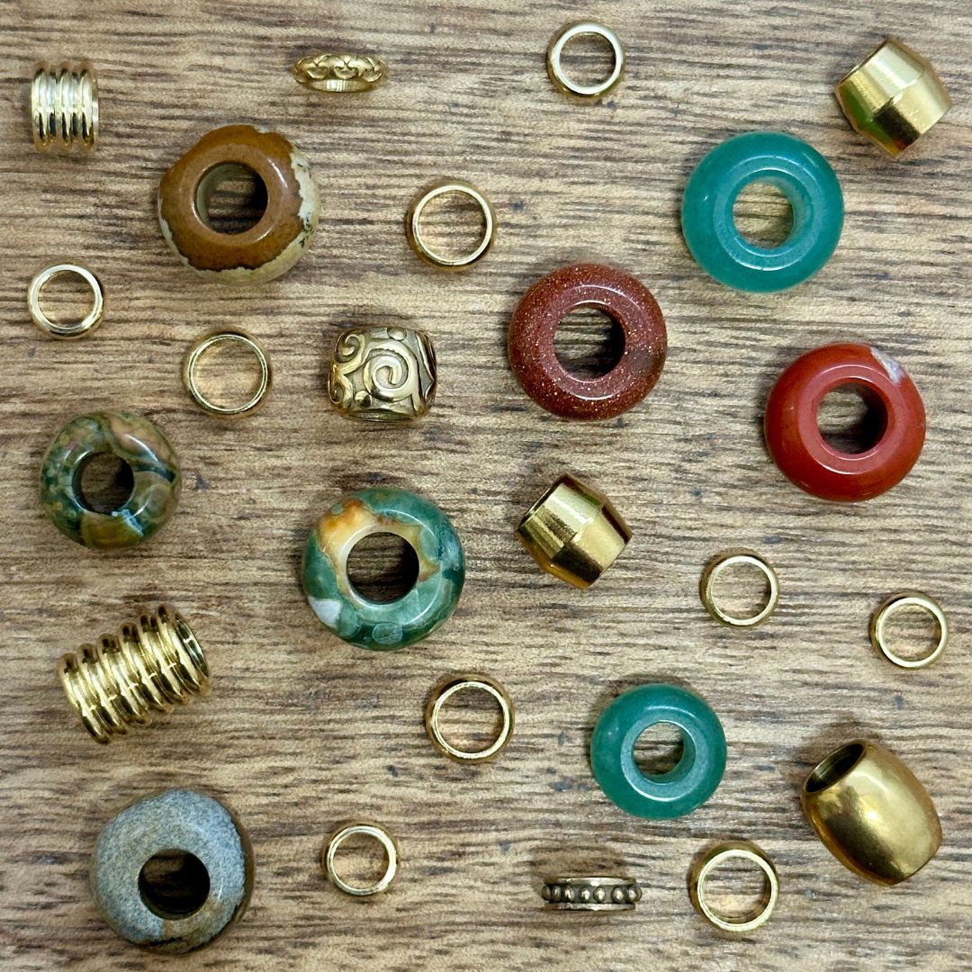 Green Gold and Red Dreadlock Beads Mix on a wooden background - Mountain Dreads