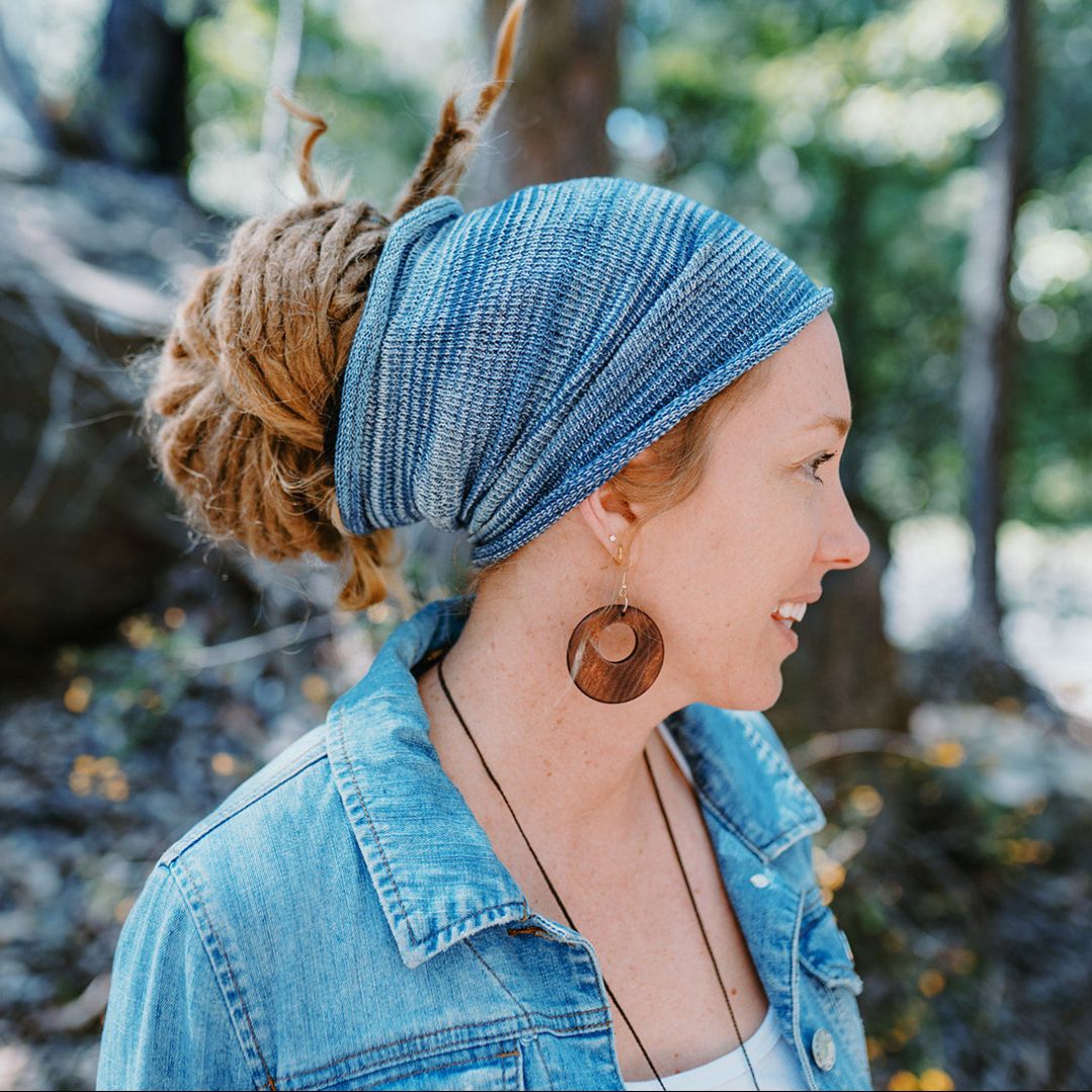 A person wearing a blue wide cotton headband.